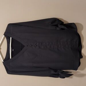 Black polyester three quarter length sleeved with ties on the side black top.